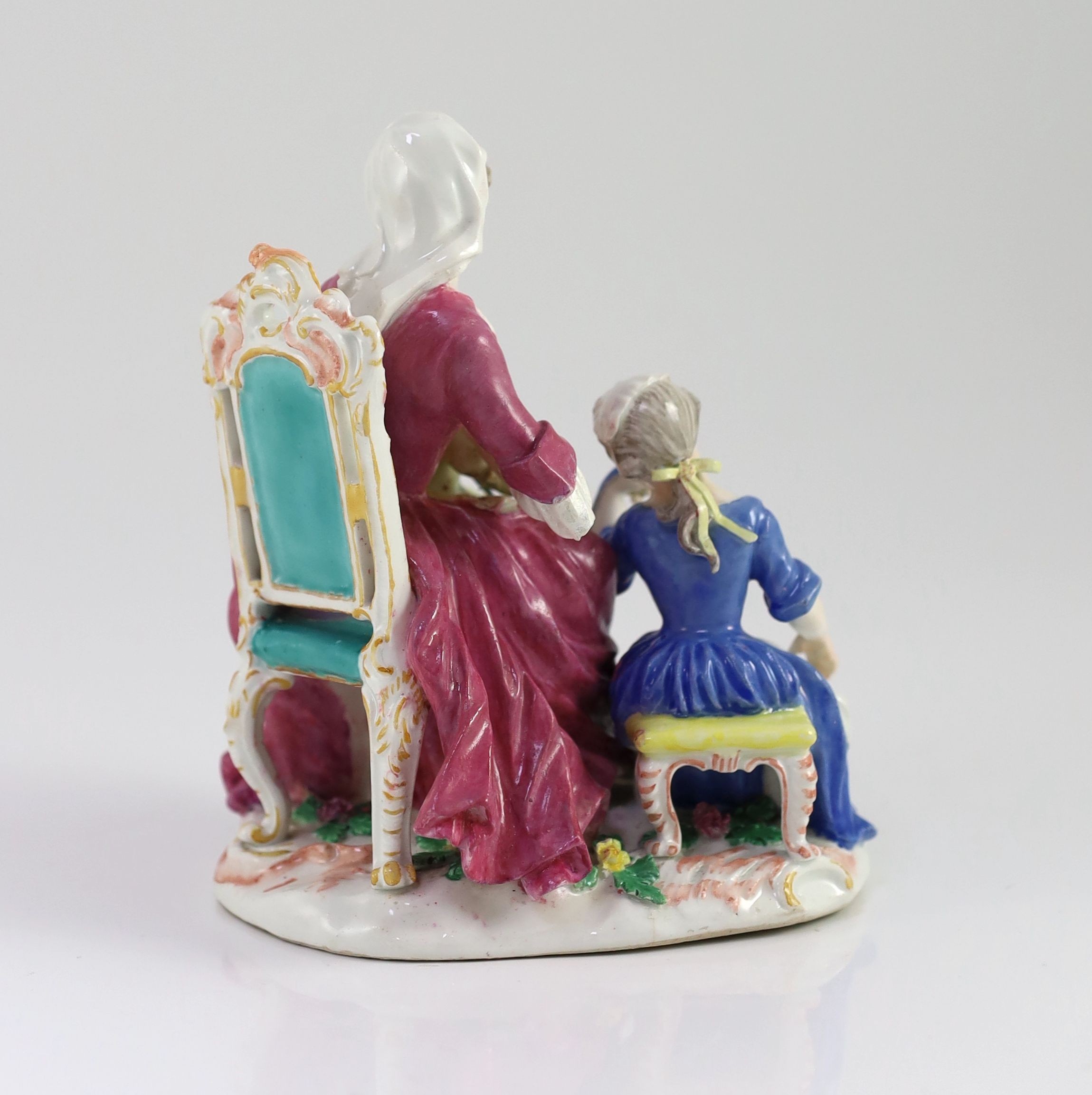 A Meissen group of a seated lady and two children, mid 18th century 16cm high, restored